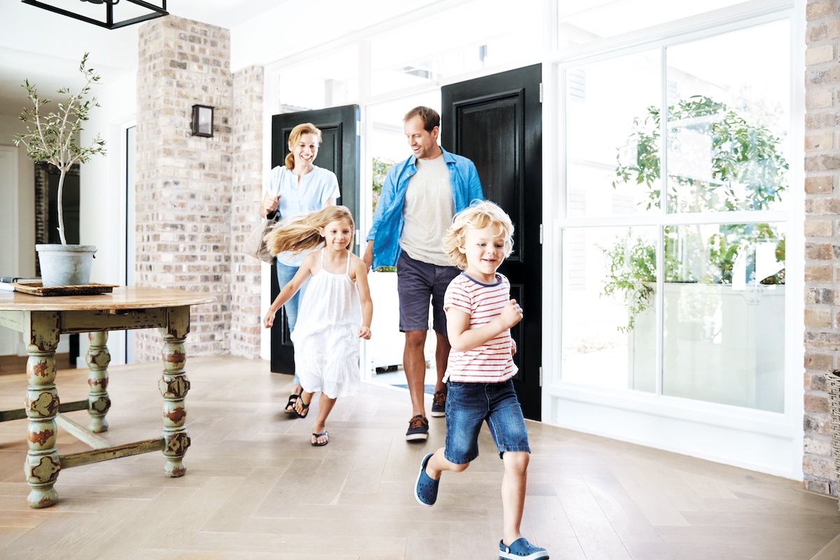 Family entering a house