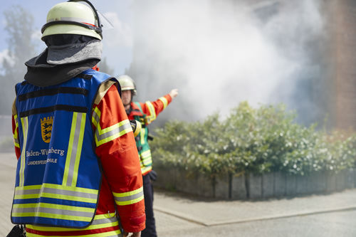 two firemen near a fire site