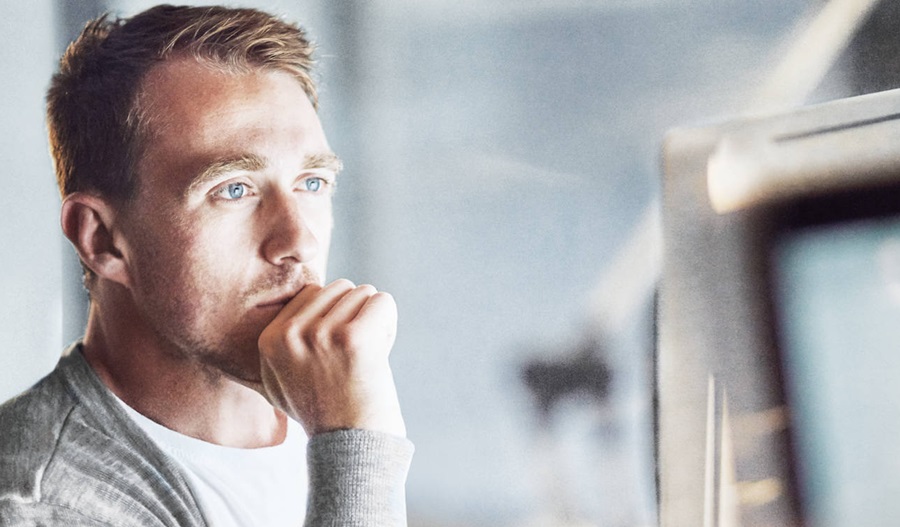 man looking at laptop screen