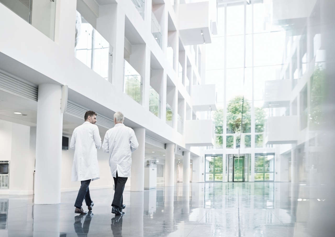 two male doctors walking in a hospital hallway