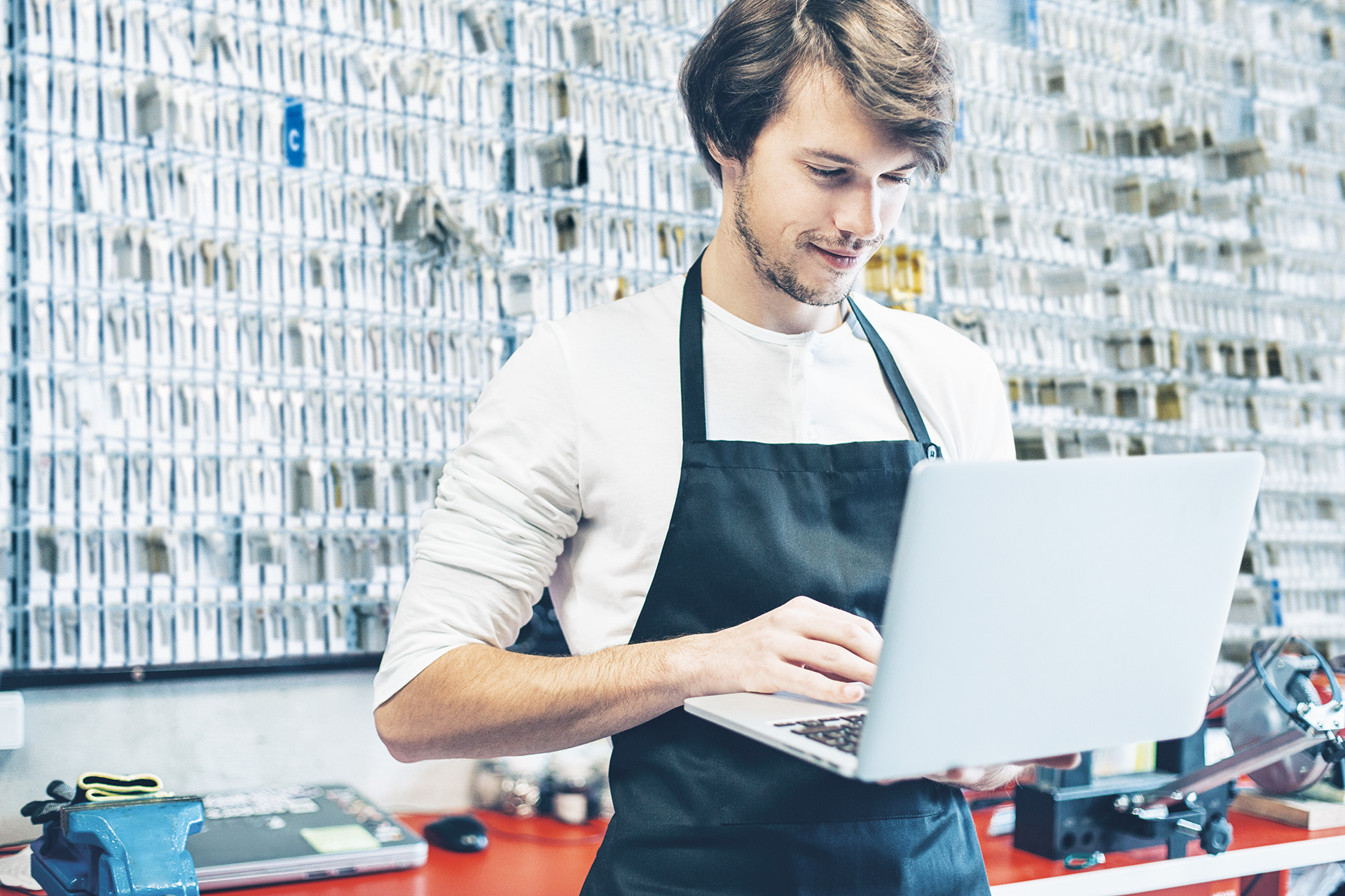 Locksmith standing behind his laptop