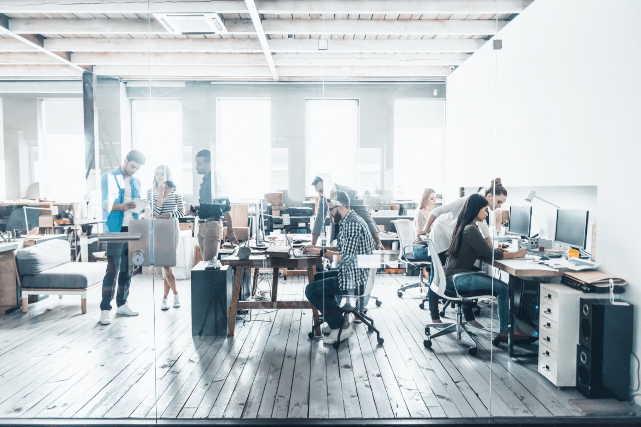 a group of people working in an open space workspace
