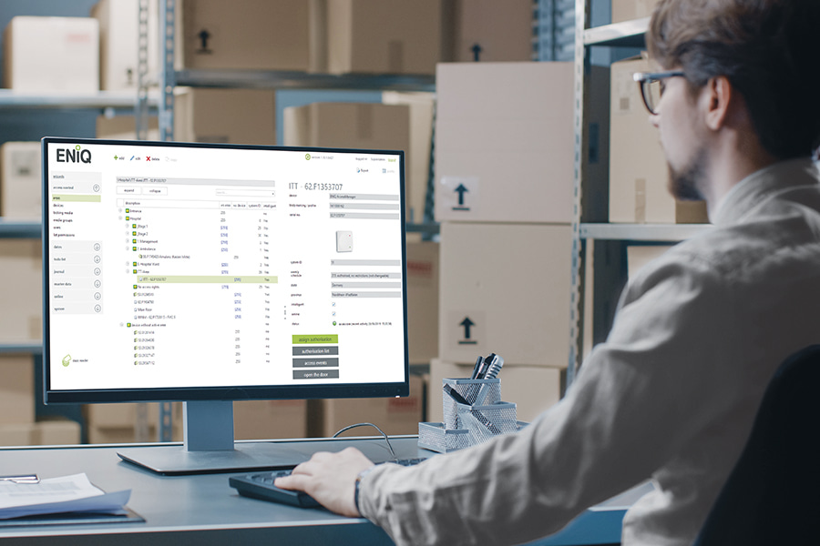 a man facing a computer with ENiQ software interface