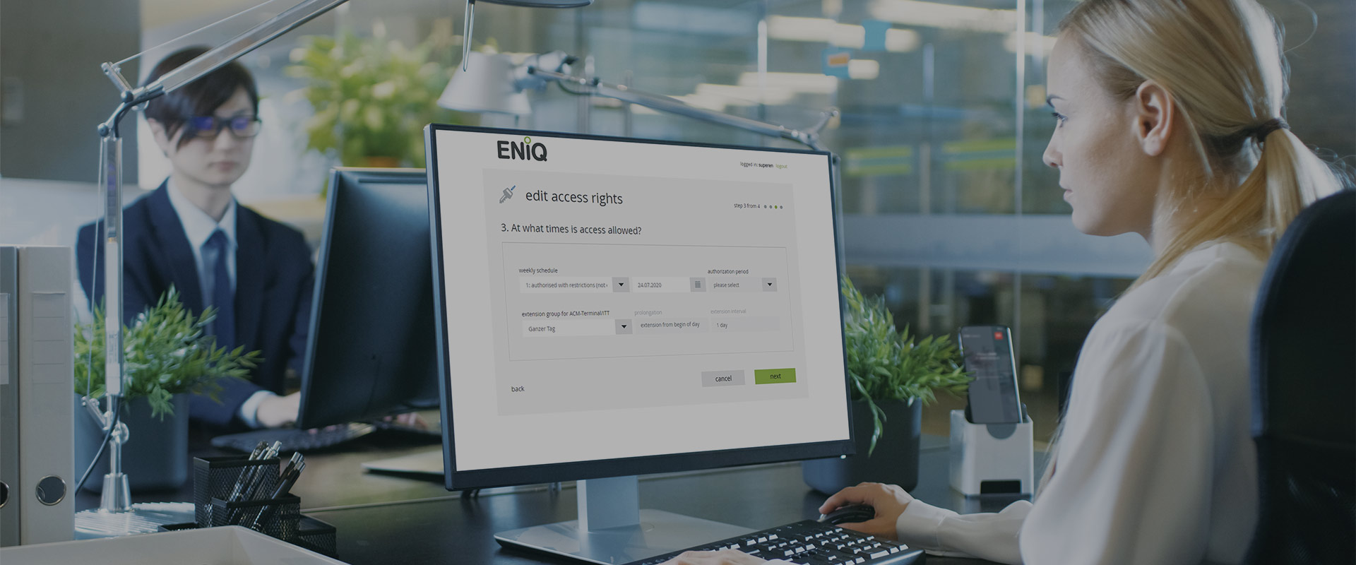 a woman sitting in front of the computer facing a software interface