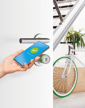 Front door with DOM Tapkey Pro cylinder, in the background a bicycle parked in the hallway