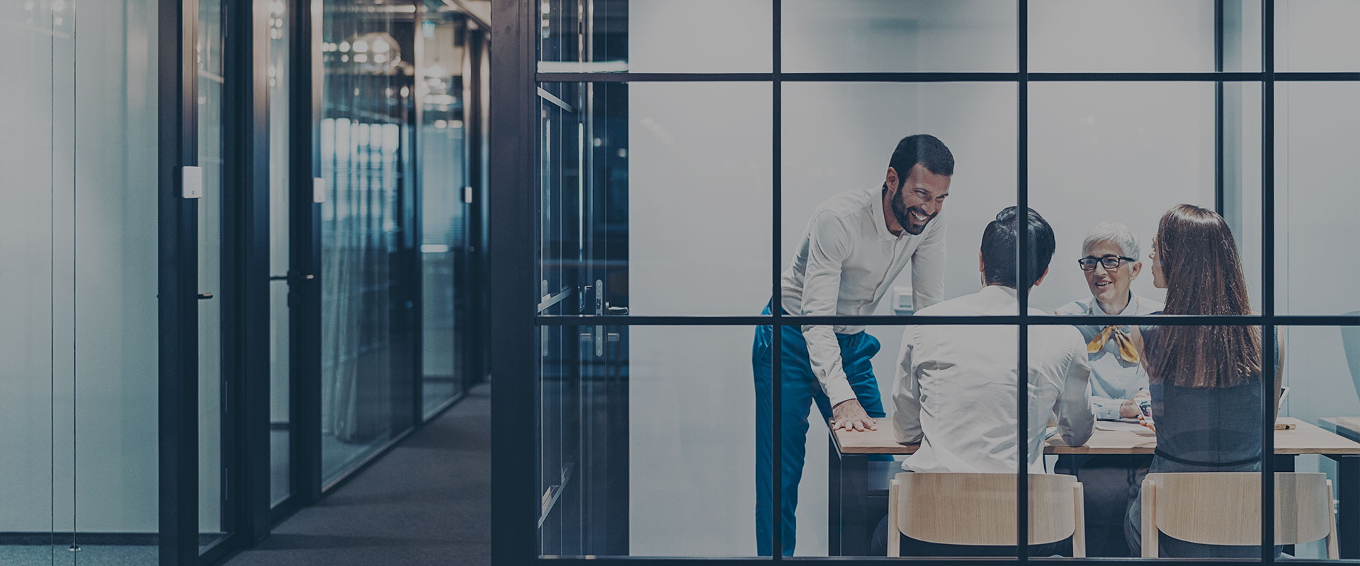 a group of people having a meeting in a room secured by DOM digital products