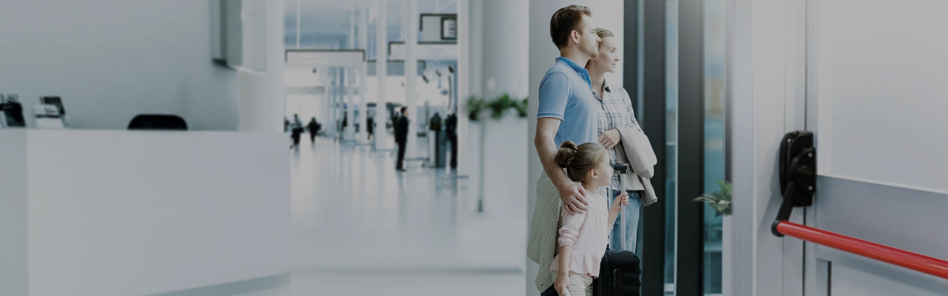 Family near emergency exit with panic push bar in a public building.
