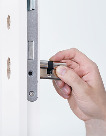 hand inserting a cylinder