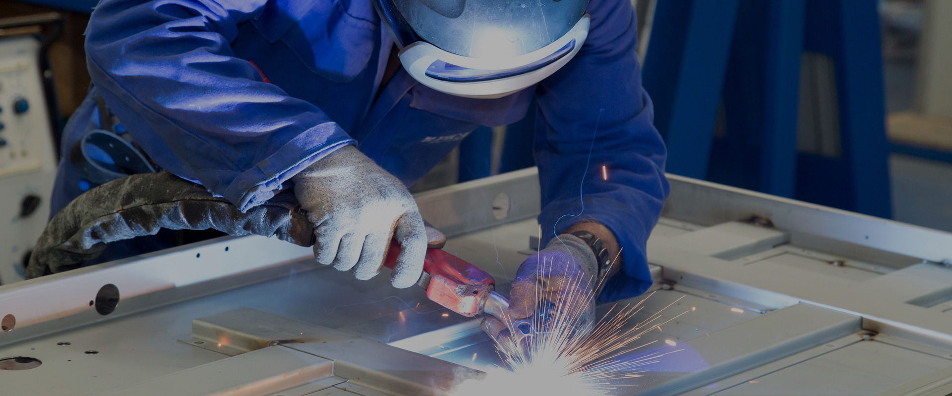 worker welding a steel door