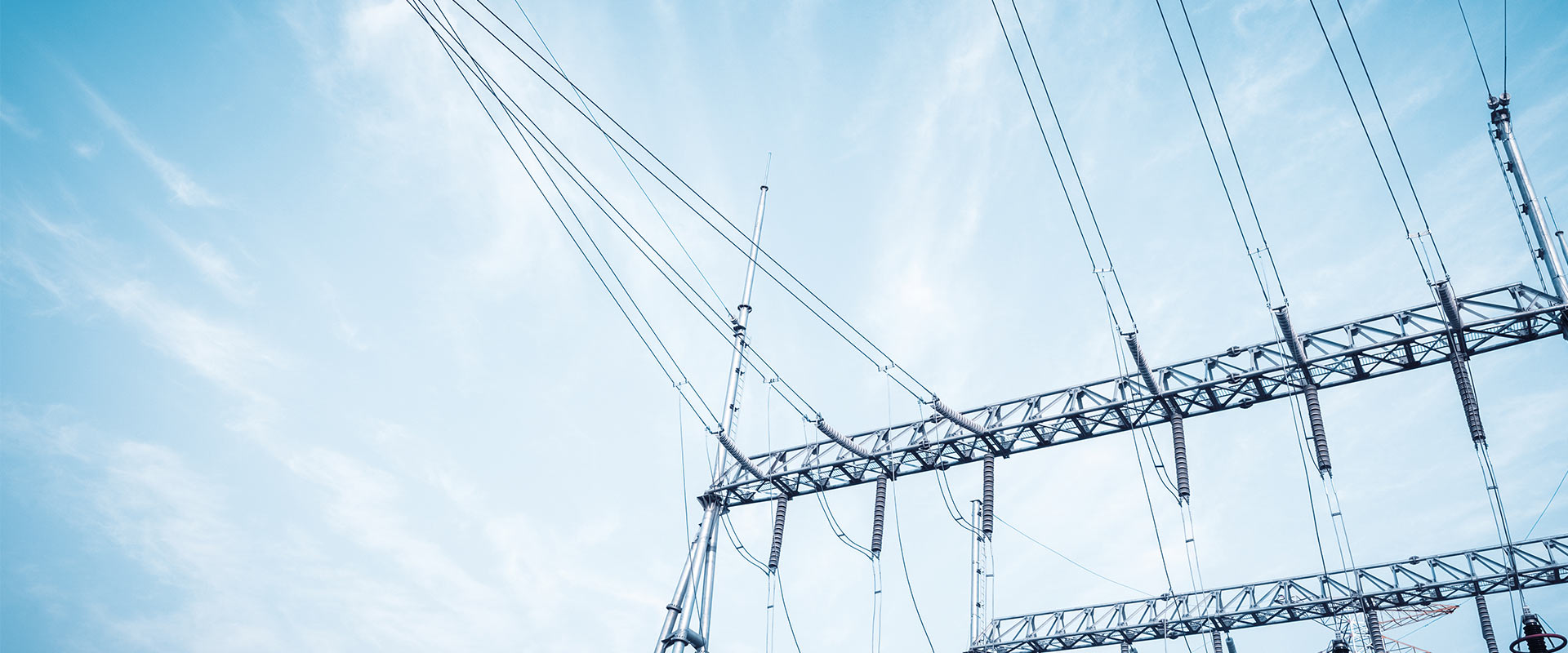 pylon with electric cables under a blue sky