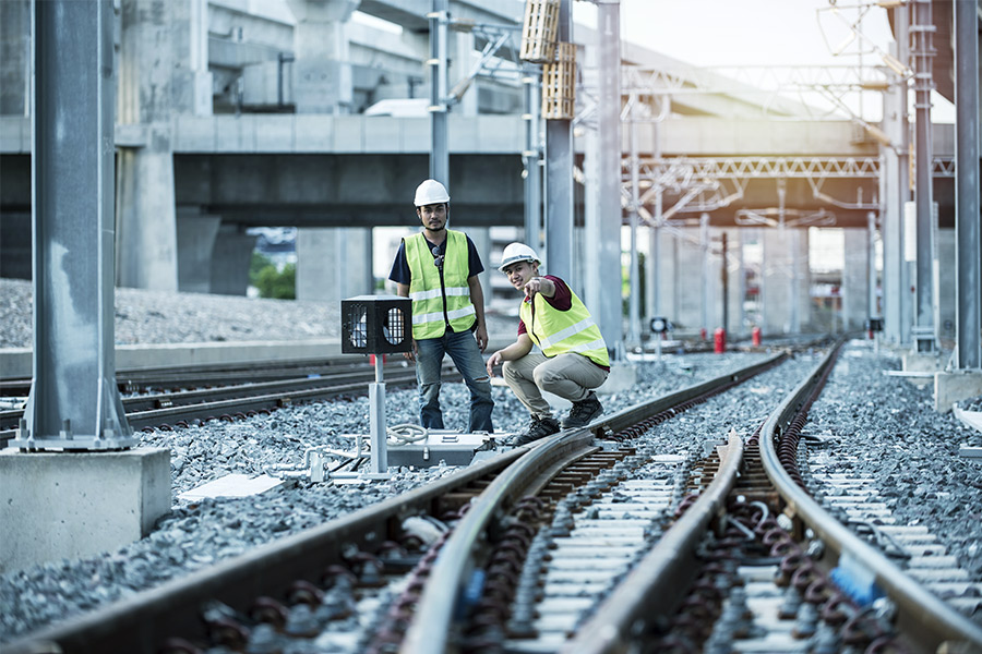 two workers work on the switch track protected by an interlocking system