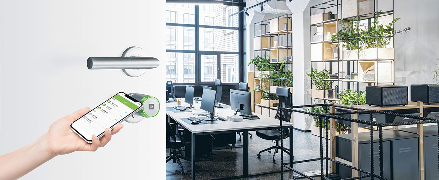 hand opening an office door secured by a digital lock via smartphone