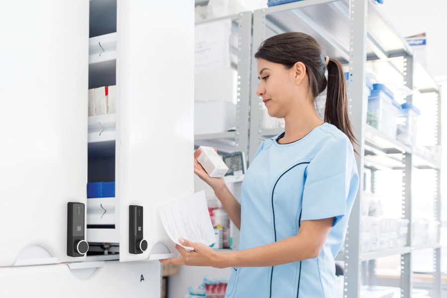 Woman opening medicine cabinet with ENiQ LoQ