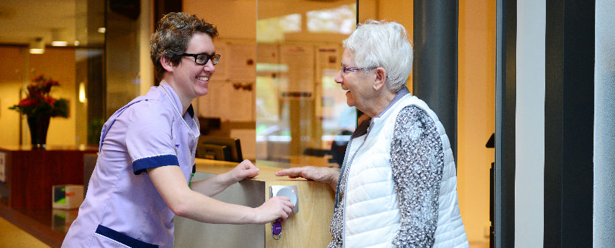 nurse woman talking with older woman