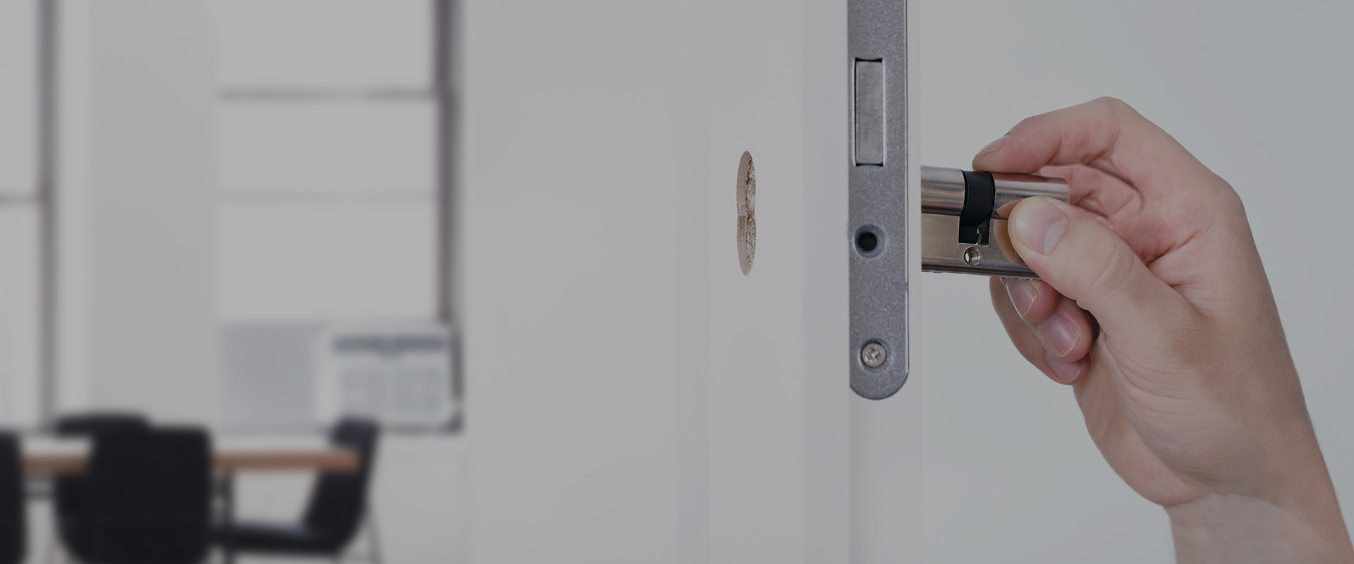 hand inserting a cylinder